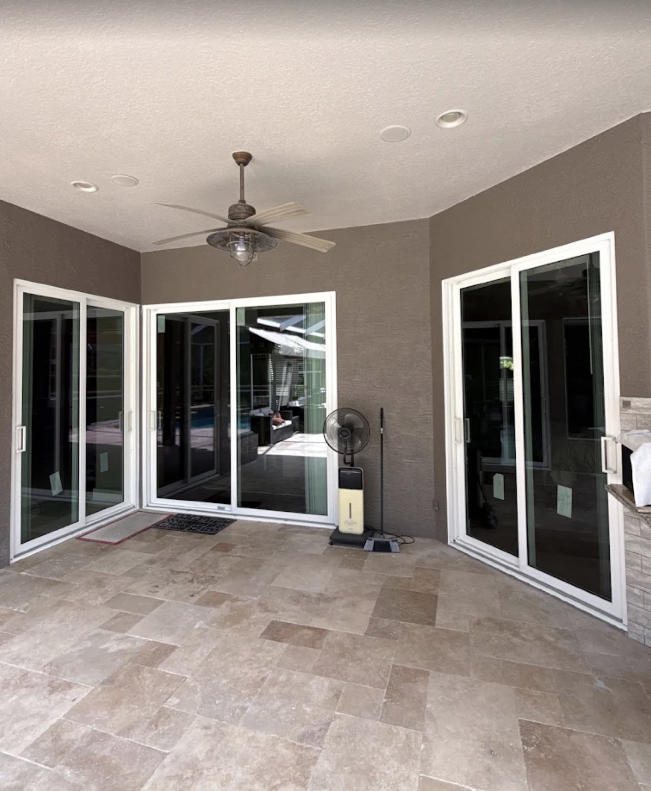 New construction sliding glass door window installation on a covered Fort Myers patio